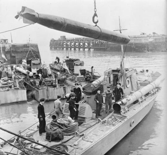 A 21&quot; torpedo is lowered onto the deck of Motor Torpedo Boat 232 in Felixstowe Harbour.