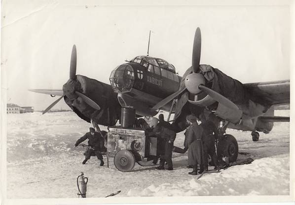 Ground crew with a Motorenanwärmer 38 (heater for engines) working on the Ju-88 D &quot;Habicht&quot; of the 3. / (F) 10 (see emblem on the nose) at the Poltava airfield - March 1942.......................