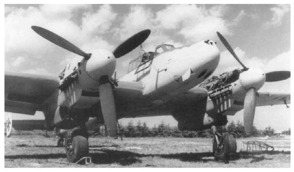 A Bf-110 G-2 in maintenance; the port engine is seen without its cover and the rear dome of the cockpit was removed ......................................
