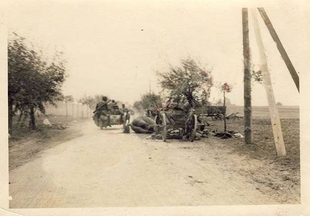 German motorcyclists pass the wreckage of a horse-drawn column...................................