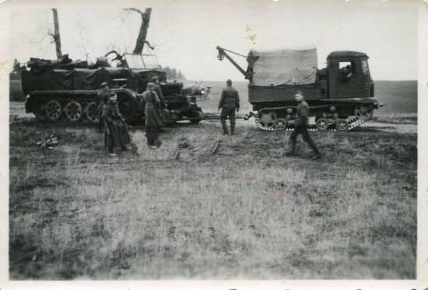 A captured Soviet tractor STZ-5 with a crane and towing axle (abschleppachse) recovering a half track..................