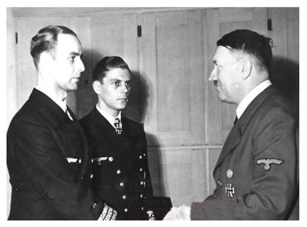 Korvettenkapitän Friedrich Kemnade receives the Oak Leaves for the Knight's Cross from the Führer, next to him in the photo Carl Emmermann .............................