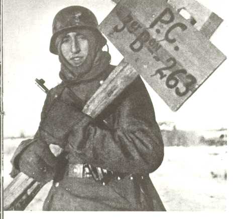 source unknown:spanish volunteer placing the hq roadsign