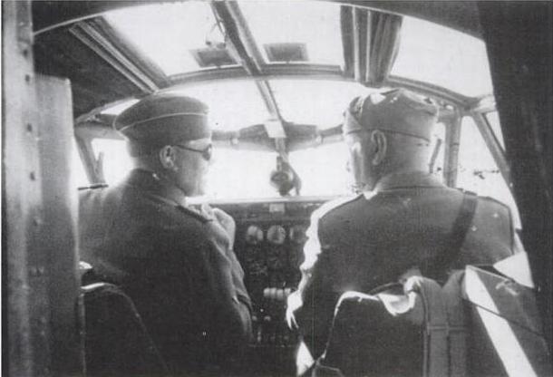 Benito Mussolini (to the right) receiving instructions from Hans Baur.