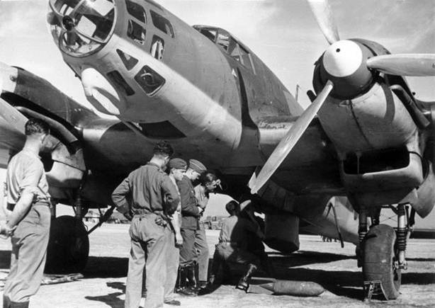 On the airfield of Levida. Hooking the bombs to a He-111E.............................