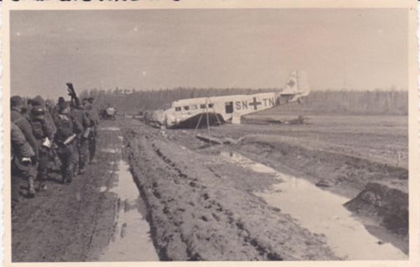 German mountain troops marching towards a Ju-52 which carried out a belly landing......................