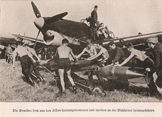 The bombs are carried towards the aircraft by the ground crew.................