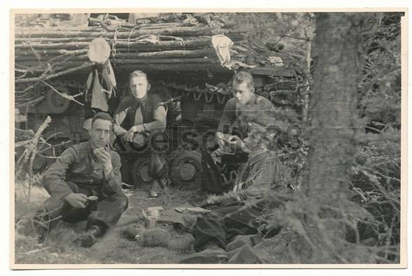 The crew of a German tank taking some snacks before the attack........................