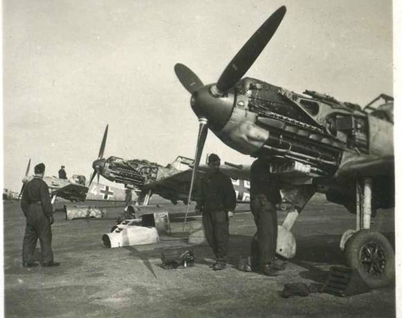 Some Bf-109 in a squadron are inspected by the mechanical staff .....................