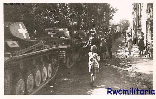 A German armored column (Pz Kw II) has caught the attention of the local population ................................