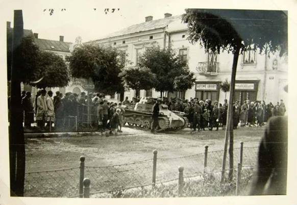 Waiting for a parade? On the street a Pz Kw I Ausf. A; to the right in the sign it's written Gotowe Ubiory (ready clothing).........................