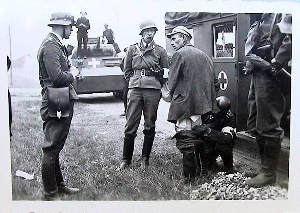 First aid to the adversary ..... The German, standing up with the white band on his left arm, was he an interpreter?............