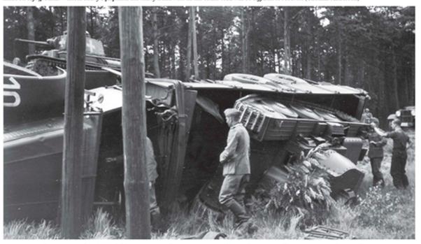 A heavy truck FAUN L 900, carrying a Pz Kw 38 (t), has rolled over one of its side ...........................