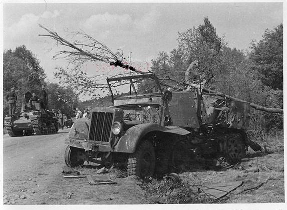 View of a half-track disabled by enemy action, in the background a Pz Kw 35 (t) .......................... ....
