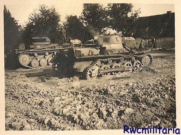 A Pz Kw I Ausf. B which has lost some of its drive train in a Polish hamlet, behind a pair of Pz Kw II ...............................