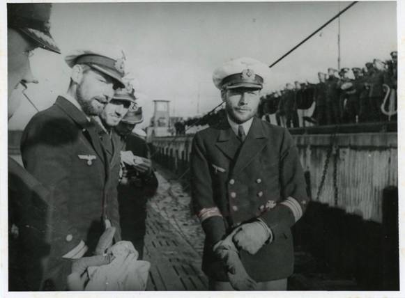 In this photo we see kplt. Otto Schuhart (I think to the right) arranging the glove on his right hand and the LI, kplt. Hermann Laufs (left); the U boat in the photo it is U 29 after the safe return to Wilhelmshaven in her first patrol.....................................