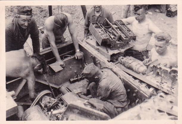 Personnel of the Workshop Platoon (Werkstatt Zug) of the III./ PR 18 working on the engine of a tank...........................