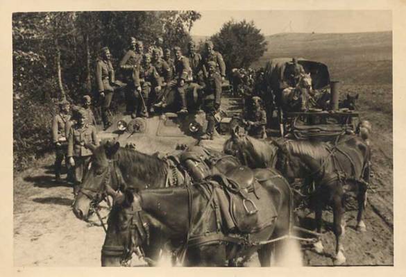 A Horse-drawn supply train column in a brief stop for a souvenir photo on a T-34 rendered useless; in the foreground a field kitchen .........................