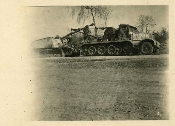 Working on a Sd. Kfz. 164 Nashorn; also in the picture a Sd.Kfz. 9/1 with a 6 ton crane.........................................
