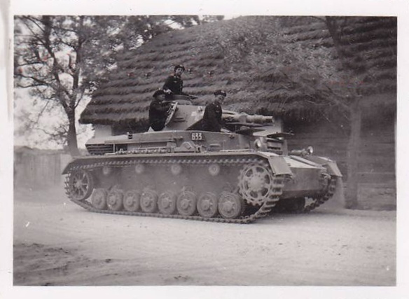A Pz Kw IV Ausf. B Nº 633 rolling by a Polish hamlet......................